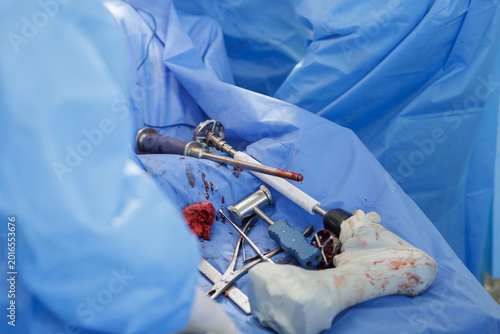 Surgical Instruments Used in Hip Replacement Procedure on Blue Sheet