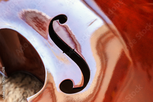 фотографія Contrabass body with f hole on glossy varnished wood close up