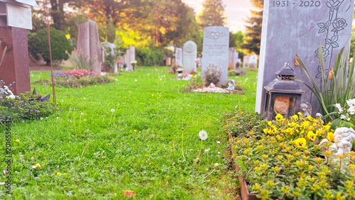 Wide cemetery lawn landscape with memorial stones during peaceful remembrance season, carefully maintained green burial grounds representing spiritual reflection, cultural respect, outdoor heritage