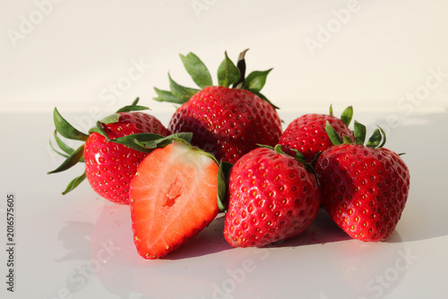 Fresh red strawberries on a white plate, white background