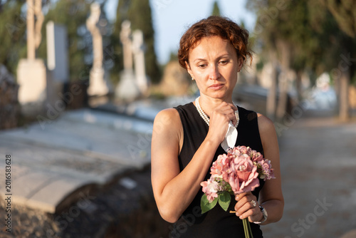 Фотография Tragic moment of visiting cemetery worshiping memory of deceased relative