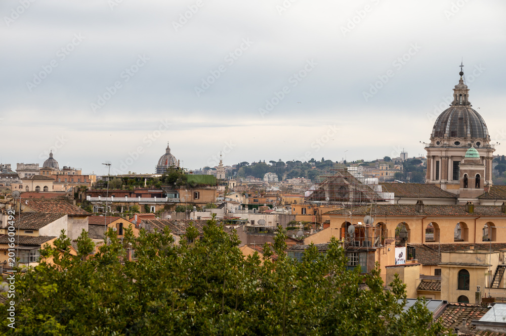Obraz premium City view on roofs and churches of Rome from panoramic route near villas Borghese and Medici, walking in Rome in spring evening, soft sunset lights, guided tour
