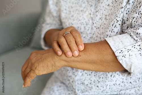 Bild auf Leinwand Elderly woman's hand and wrist showing skin texture age spots with arthritis joi