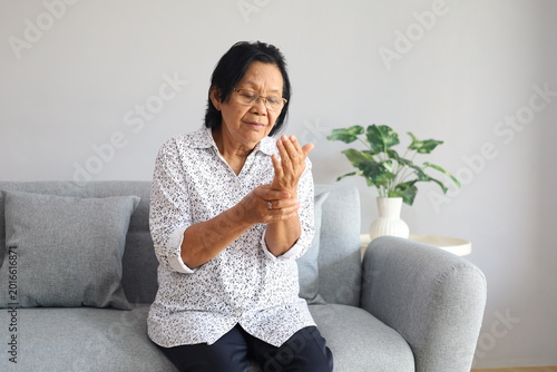 Photos Asian mature woman do daily checkup, check pulse on wrist at home, sick elderly