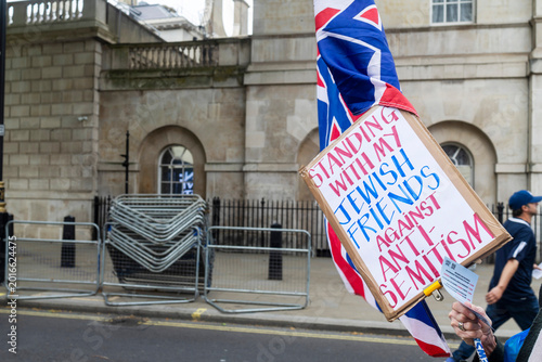 London, UK, Thousands of people gathered outside Downing Street for a protest against antisemitism. Cardboard protest sign saying Standing with my Jewish friends against anti-semitism 