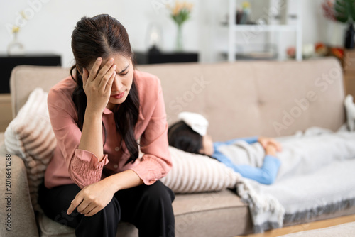Photos Stressed Asian Mother Worried About Her Sick Daughter at Home