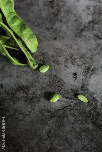 Bitter bean on black background. Green Organic produce commonly used in Asian cooking and street food