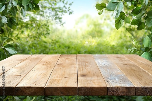 Empty wooden table on nature background with lush green leaves and bright sunlight in sunny outdoor setting