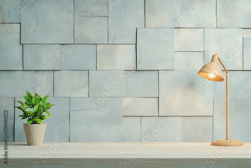 Modern minimalist workspace with a potted plant and a wooden desk lamp against a textured concrete wall