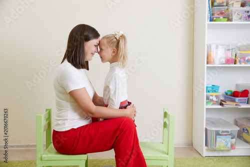 Photos Cheerful daughter looking at overjoyed mother laughing having fun