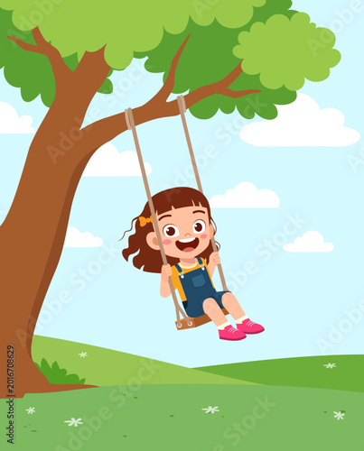 Happy young girl with a wide open mouth smile enjoying a delightful ride on a tree swing outdoors