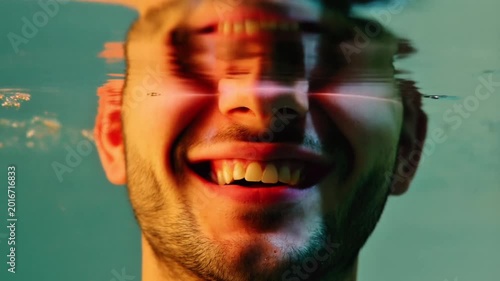 Smiling man's face partially underwater with digital glitch and bright light effect