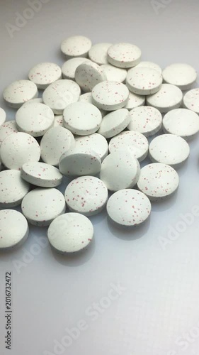 Close-up of a scattering of pills. Vertical video.