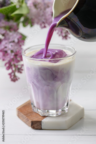 Ube latte in glass. Healthy vegan drink. Viral trendy asian beverage
