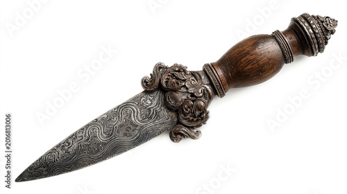 Indonesian kris dagger with wavy blade and carved handle, isolated on a white background 