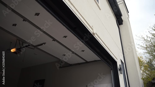 Automated garage Door closes. Residential house. Outside footage.