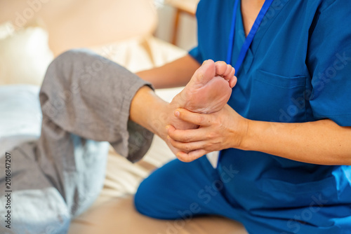 Konstfotografi Asian male physical therapist assisting senior patient leg stretching exercise a