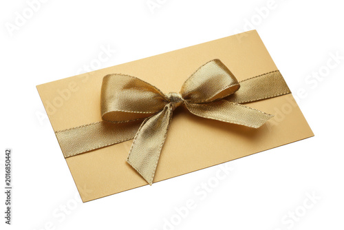 Gold ribbon tied in a bow on a golden card against black background image
