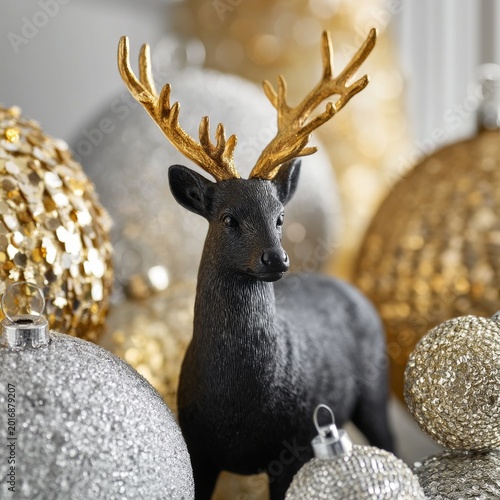Black Deer Figure Stands Among Golden and Silver Ornaments During Holiday Season