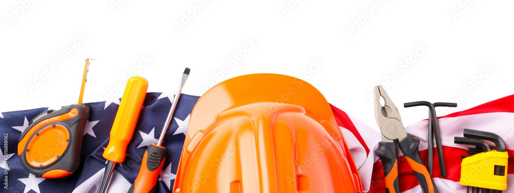 Naklejka premium Construction tools on American flag for Labor Day celebration
