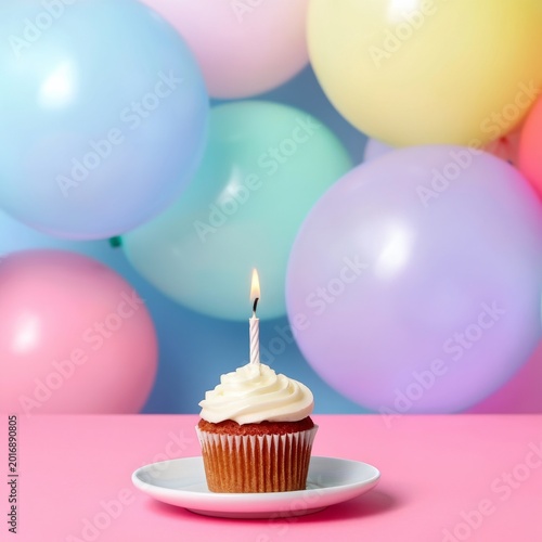 Cupcake With a Candle and Colorful Balloons at a Birthday Celebration in a Br...