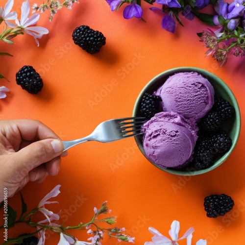 Enjoying Purple Ice Cream With Fresh Blackberries and Flowers at a Vibrant Ta...