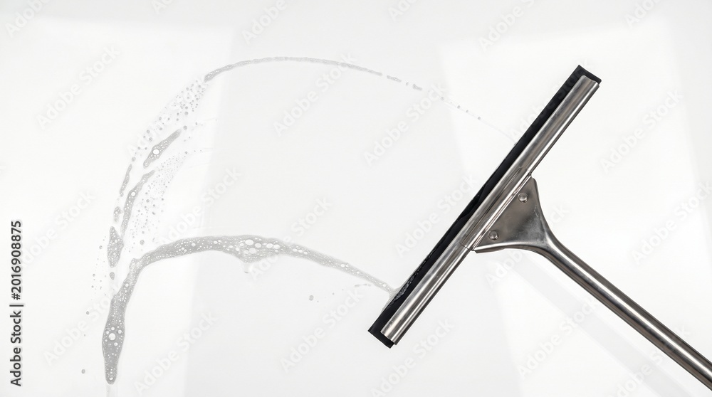 Obraz premium Squeegee with water on glass surface.