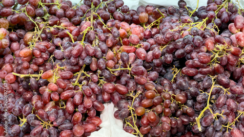 Fotografie Close-up of ripe red grapes, fresh and dewy, arranged in dense bunches