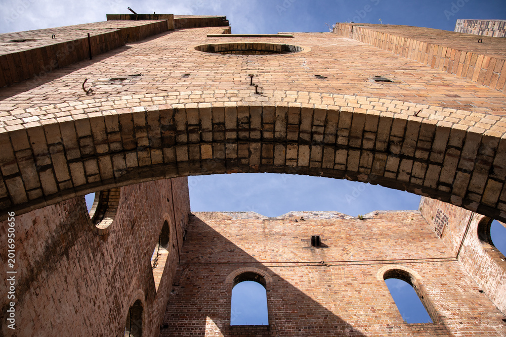 Fototapeta premium Historic Brick Ruins Against Blue Sky