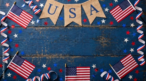 USA flags and decorations on a rustic blue wooden background