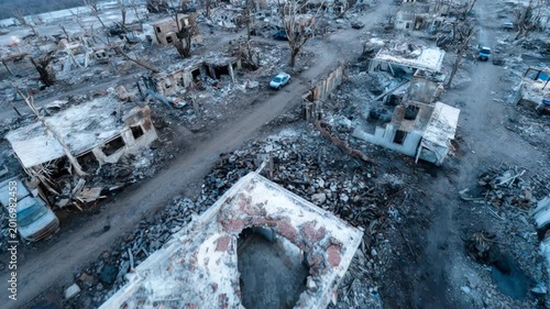 Drone view of bombed houses and ruins in a city destroyed by war and disaster