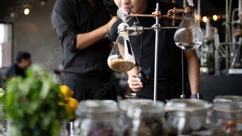 Tableau sur toile Close up Perfumers Creating Fragrance in Modern Laboratory with Botanical Ingred