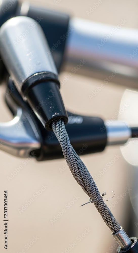 Naklejka premium Close-up of Bicycle Brake Cable and Handlebar Detail in Focus.
