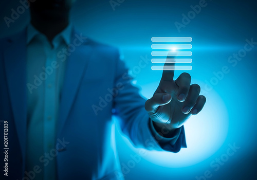 Man in suit touching glowing digital interface with finger