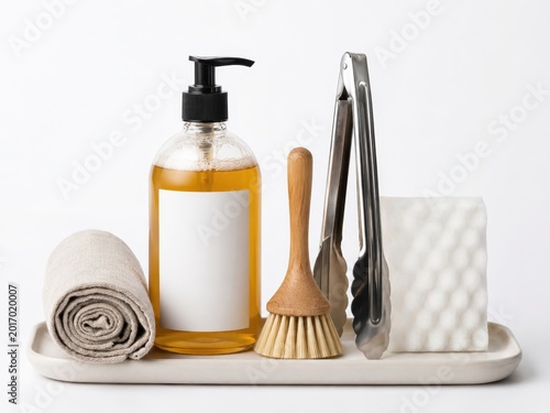 Minimalist dish care kit with amber detergent bottle wooden brush tongs sponge and linen towel
