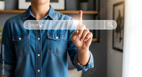 Person's finger touching a search bar on a digital screen, representing online searching and information access.