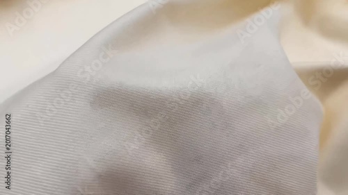 The premium cream white gabardine twill fabric displays a fine diagonal weave and a soft smooth finish. This durable material is perfect for creating high quality tailored suits and trousers.