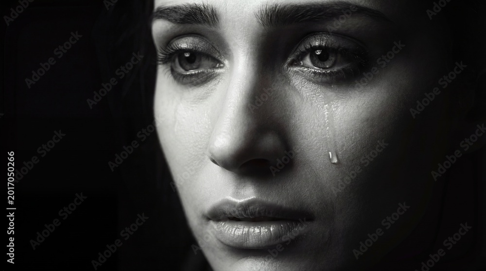 Fototapeta premium Black and white portrait of woman in tears concept. An emotional portrait capturing sadness and reflection in a person.