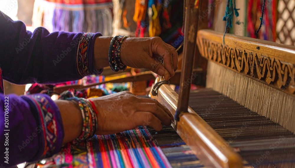 Fototapeta premium Peruvian woman weaving colorful textiles on traditional wooden loom