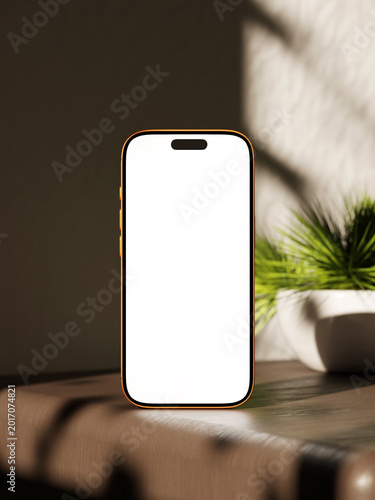 Modern smartphone mockup on a wood table with natural plant and light shadows.