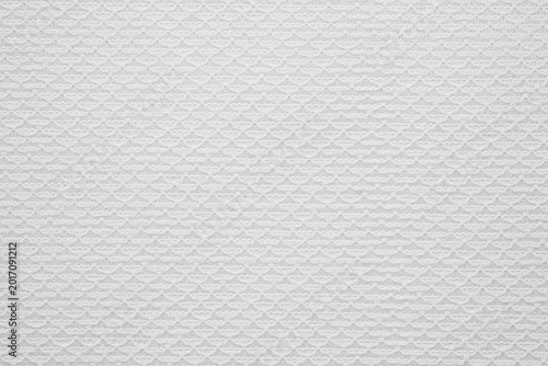 Close up of white textured fabric with a repeating geometric surface detail for background use