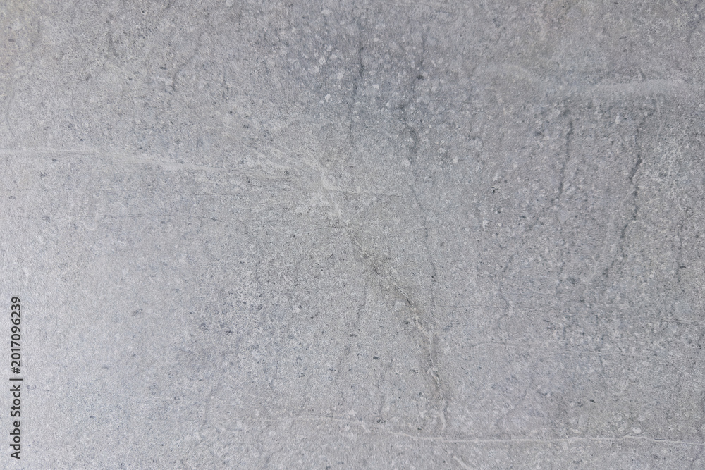 Fototapeta premium Close-up view of textured gray concrete surface with subtle variations and patterns