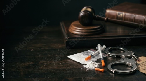 Criminal Justice Concept with Drug Evidence, Handcuffs, and Gavel on Dark Background. Professional Hero Header for Legal Services, Crime News, and Law Reform Commercial Projects.