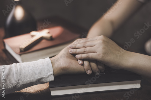 Εκτύπωση καμβά Christian group of people holding hands praying worships together to believe and Bible on wooden table for devotional for prayer meeting