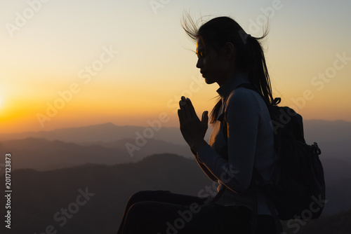 Religious young woman praying to God in the morning, spirtuality and religion, Religious concepts