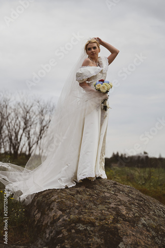 Bride with bouquet outdoors. Lifestyle and wedding concept.