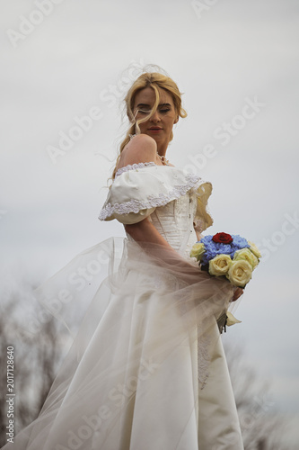 Bride with bouquet outdoors. Lifestyle and wedding concept.
