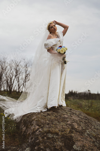 Bride with bouquet outdoors. Lifestyle and wedding concept.