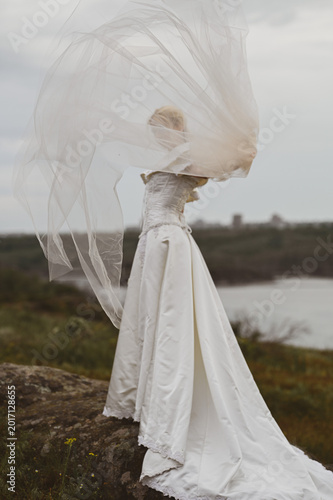 Bride with bouquet outdoors. Lifestyle and wedding concept.