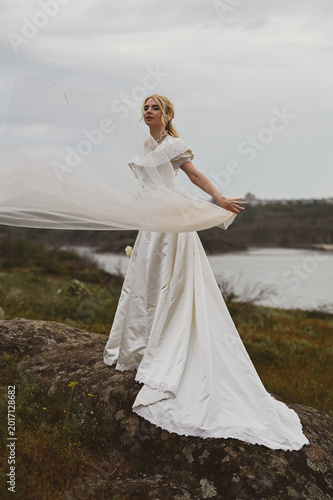 Bride with bouquet outdoors. Lifestyle and wedding concept.